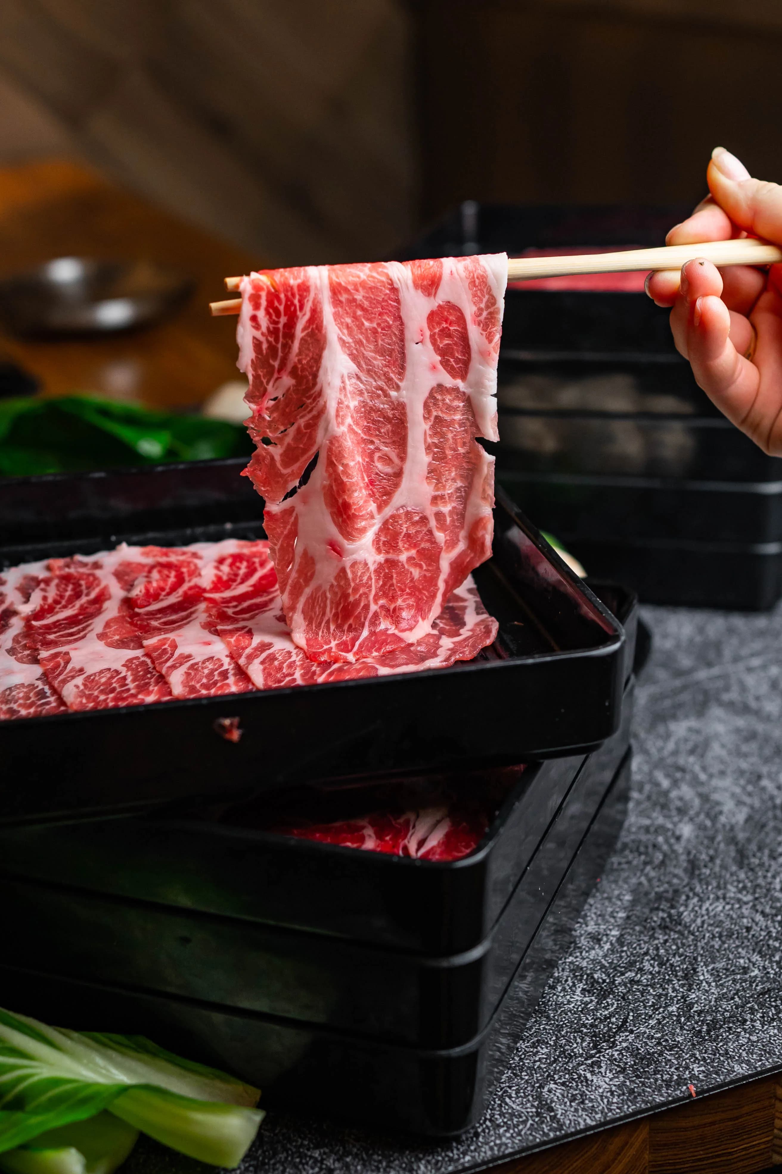 Wagyu slice lifted with chopsticks